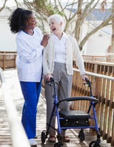 caregiver and woman with walker